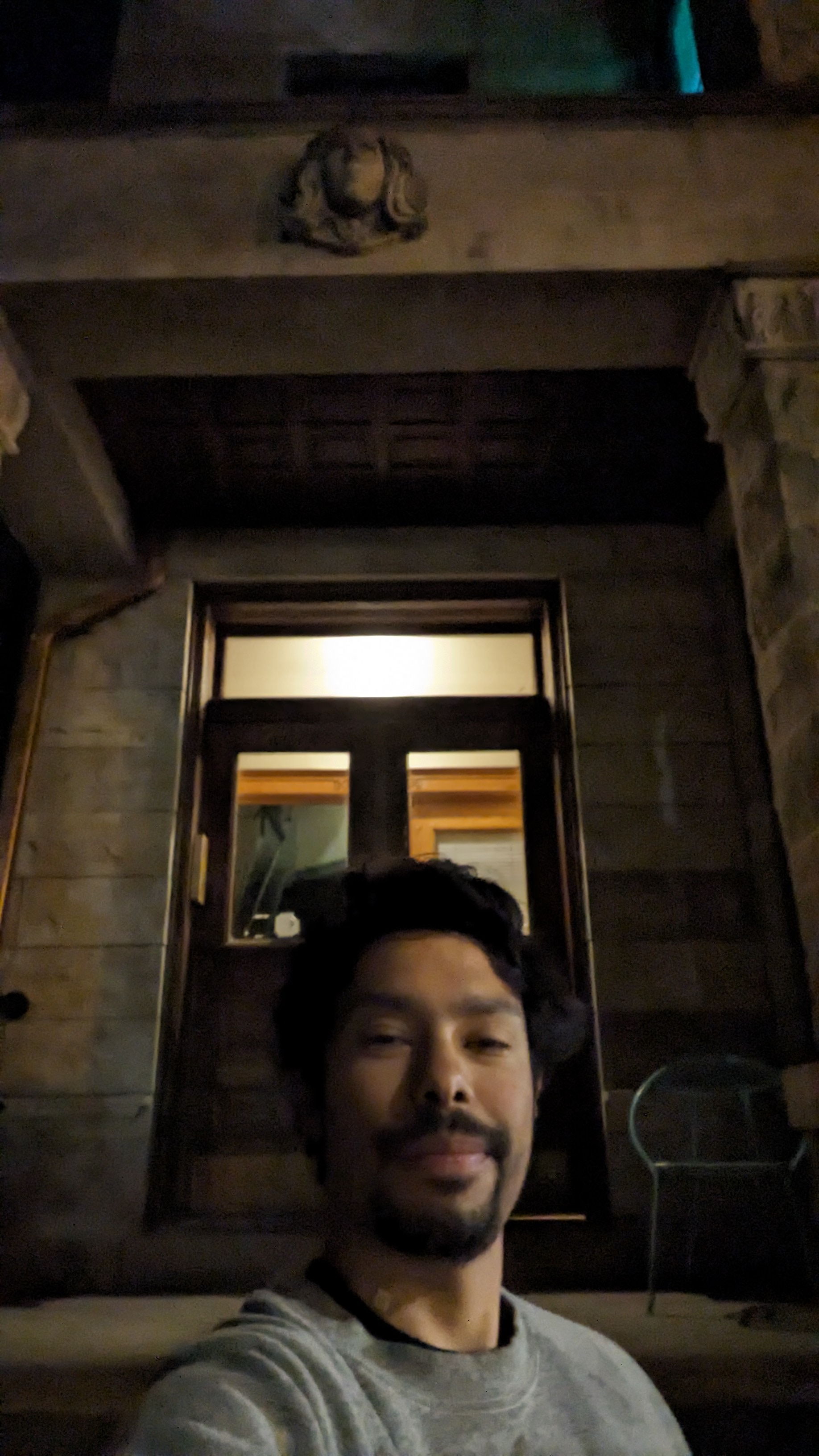 Tyler standing outside his apartment on the last night of his lease